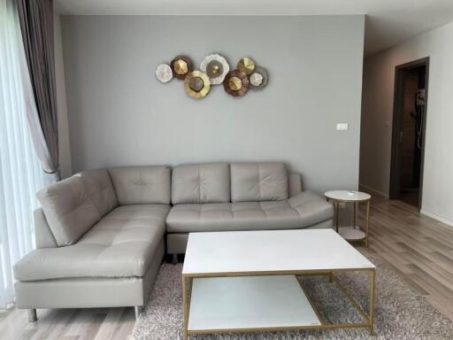 Living room with gray sectional sofa and modern decor