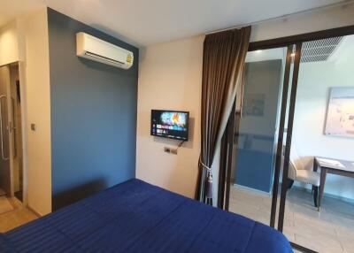 Bedroom with a wall-mounted TV and air conditioning