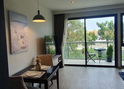 Living room with dining table and balcony view