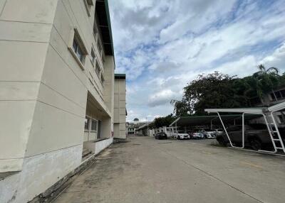 Exterior view of a building complex with parking area