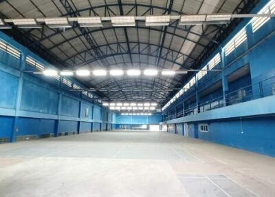 Large indoor sports facility with blue walls and high ceilings