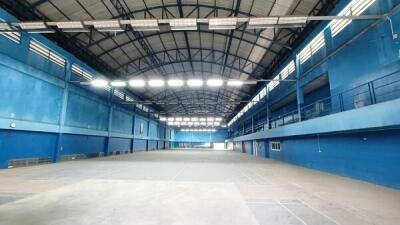 Large indoor sports facility with blue walls and high ceilings