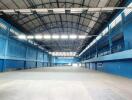 Large indoor sports facility with blue walls and high ceilings