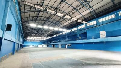 Indoor sports facility with high ceilings and blue walls