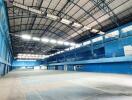 Indoor sports facility with high ceilings and blue walls