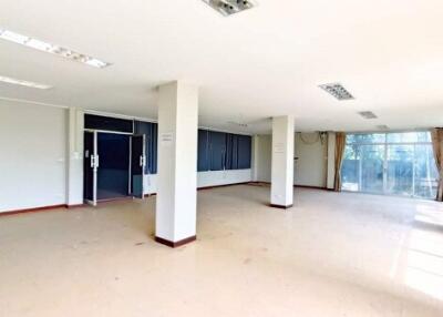 Spacious main living area with bright windows