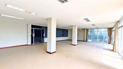 Spacious main living area with bright windows