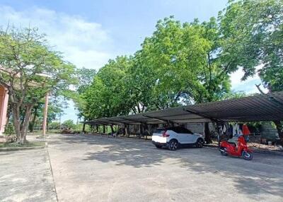 Parking area with carports and vehicles