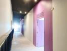 Brightly lit corridor with purple and white walls