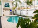 Outdoor pool area with seating and garden