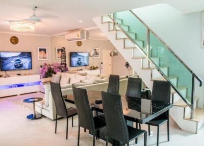 Spacious living room with dining area and staircase