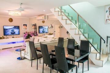 Spacious living room with dining area and staircase