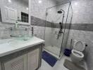 Modern bathroom with glass shower, vanity, and toilet