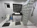 Modern bathroom with tiled walls and a glass-block shower