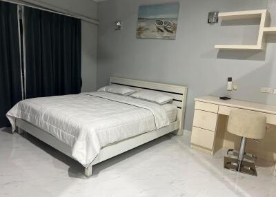 Spacious and modern bedroom with desk and large bed