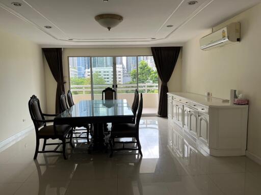 Spacious dining room with large window and city view