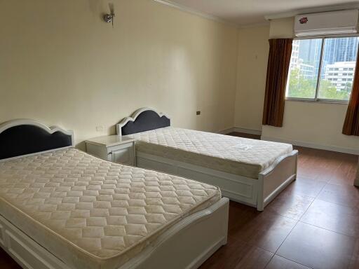 spacious bedroom with two single beds