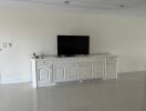 Living room with TV on a white entertainment center