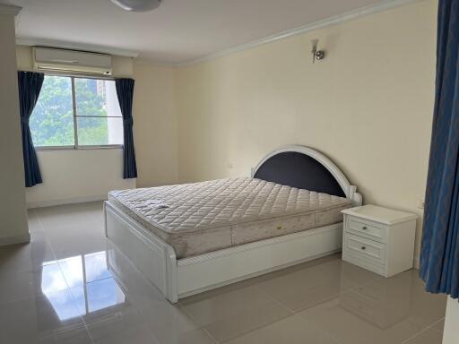 Spacious bedroom with large bed and window