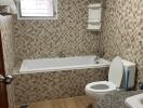 Bathroom with bathtub and tiled walls