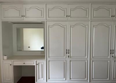 Bedroom with built-in wardrobes and a vanity desk