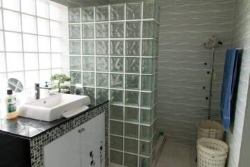 Modern bathroom with glass block wall and vanity