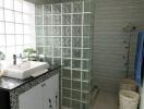 Modern bathroom with glass block wall and vanity