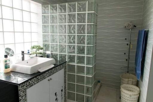 Modern bathroom with glass block wall and vanity