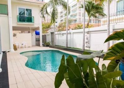 Outdoor swimming pool area with surrounding buildings