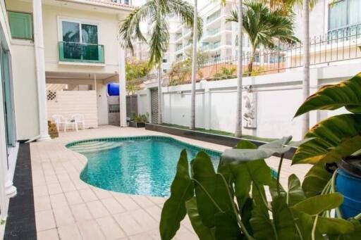 Outdoor swimming pool area with surrounding buildings