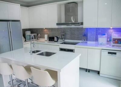 Modern white kitchen with stainless steel appliances