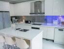 Modern white kitchen with stainless steel appliances