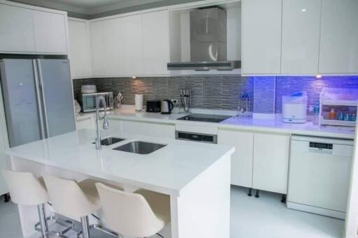 Modern white kitchen with stainless steel appliances