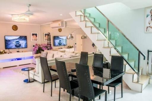 Modern living and dining area with staircase