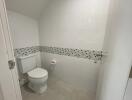 Modern bathroom with white tile walls and a mosaic tile border