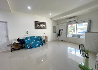 Spacious living room with large window and minimalist decor