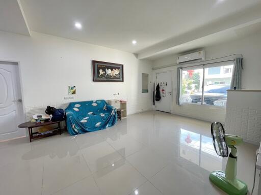 Spacious living room with large window and minimalist decor