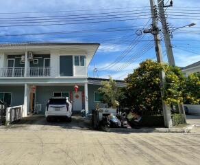 View of house exterior with driveway and parked car