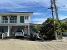 View of house exterior with driveway and parked car