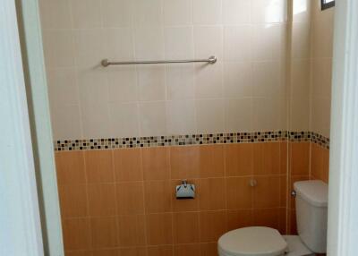 Bathroom with tiled walls and toilet