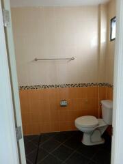 Bathroom with tiled walls and toilet