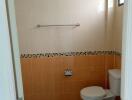 Bathroom with tiled walls and toilet