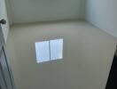 Empty white bedroom with a window