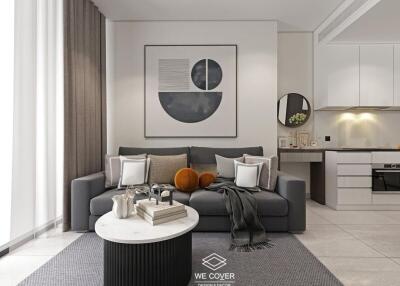 Modern living room with a grey sofa, abstract wall art, and a kitchen