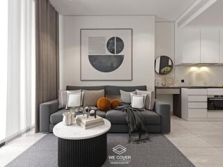 Modern living room with a grey sofa, abstract wall art, and a kitchen