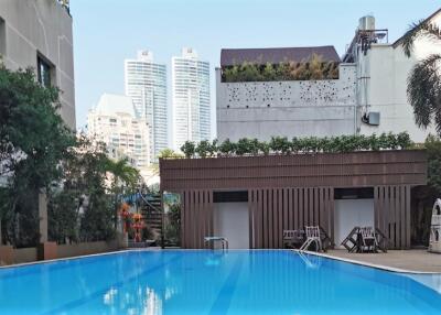 Outdoor swimming pool area with city view