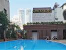 Outdoor swimming pool area with city view