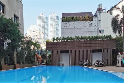 Outdoor swimming pool area with city view