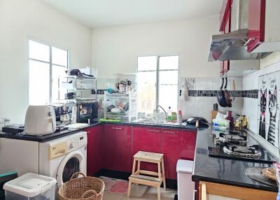 Well-equipped kitchen with red cabinetry