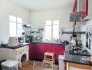 Well-equipped kitchen with red cabinetry